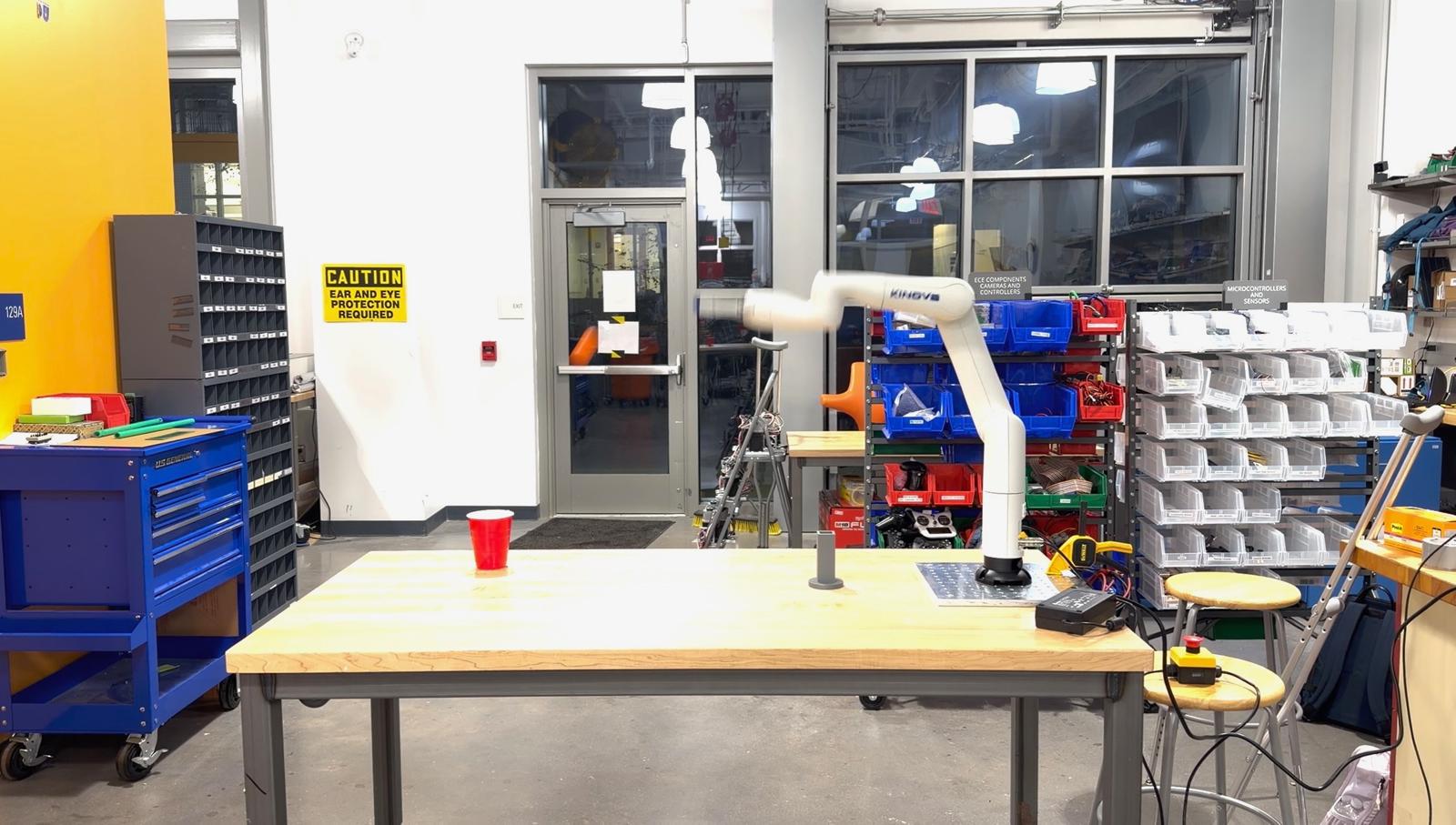 Kinova Gen3 Lite arm after releasing a ping-pong ball toward a cup target.
