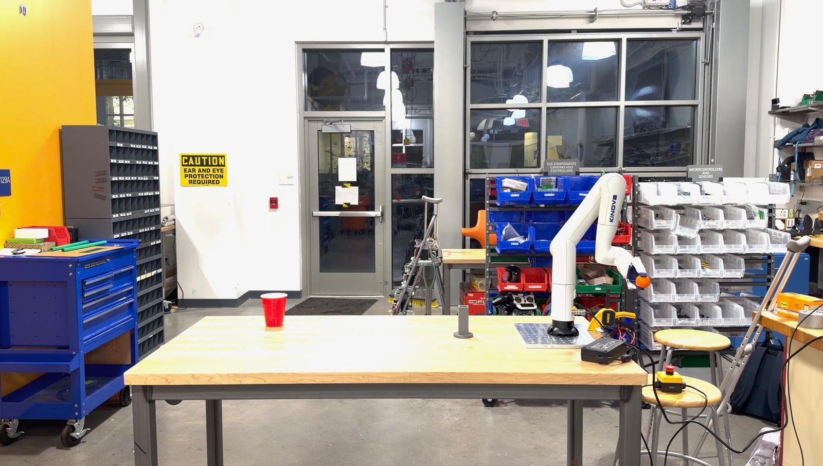 Kinova Gen3 Lite arm in its wind-up pose before throwing a ping-pong ball.